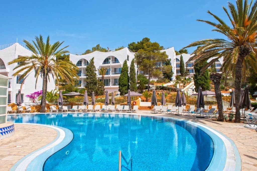 Onside outdoor pool with lounge beds and umbrellas